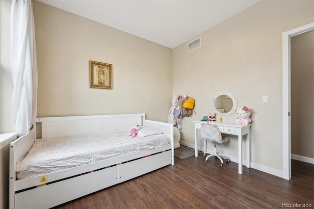 bedroom featuring baseboards, visible vents, and dark wood-style floors