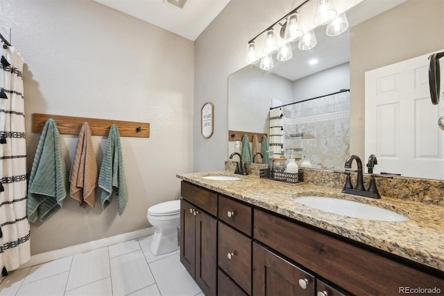 full bath featuring double vanity, toilet, a sink, and tile patterned flooring