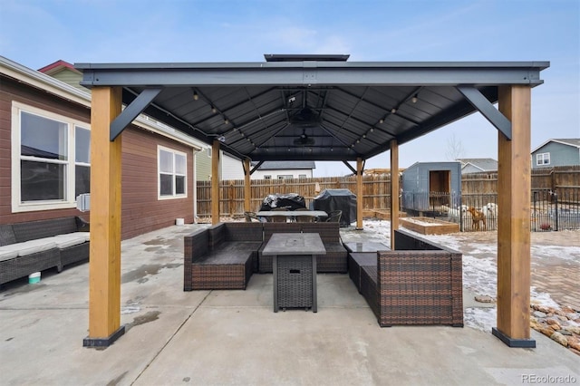 view of patio / terrace with an outdoor hangout area, a gazebo, a storage shed, and a fenced backyard