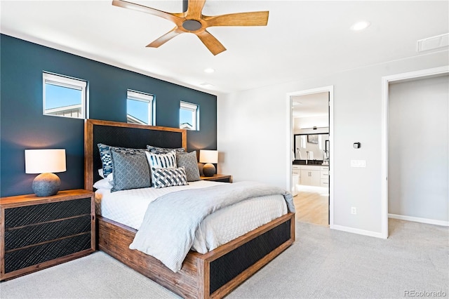 carpeted bedroom featuring connected bathroom and ceiling fan