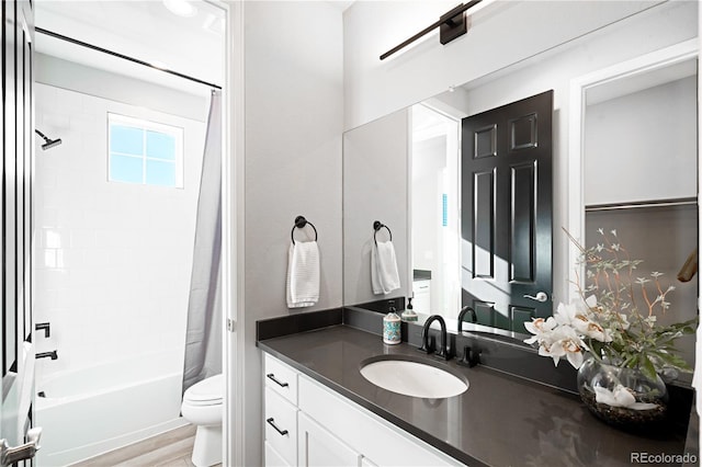 full bathroom with hardwood / wood-style floors, vanity, toilet, and shower / bath combo with shower curtain