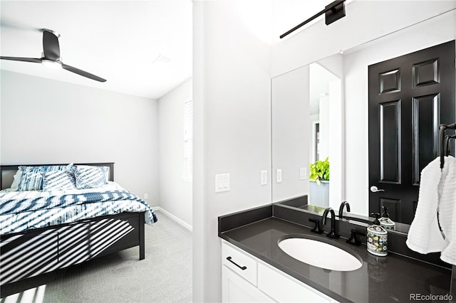 carpeted bedroom with ceiling fan and sink