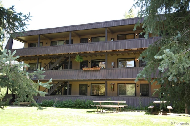 back of property featuring a balcony