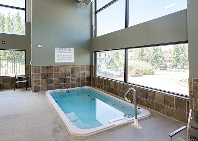 view of pool featuring an indoor hot tub