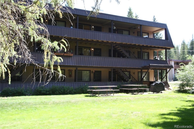 rear view of property with a lawn