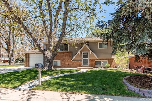 view of front facade featuring brick siding, driveway, a front yard, and a garage