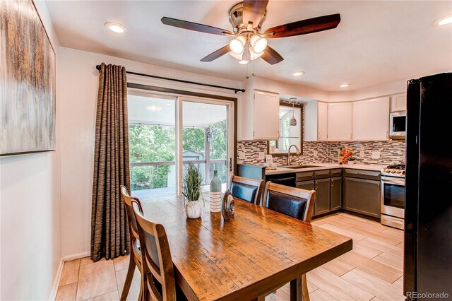 dining space with a ceiling fan and recessed lighting