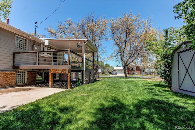 view of green lawn with a storage shed, an outdoor structure, a deck, and a patio