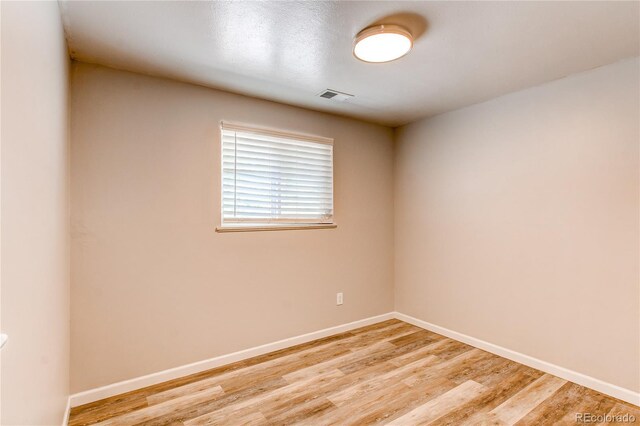 unfurnished room featuring light wood finished floors and baseboards