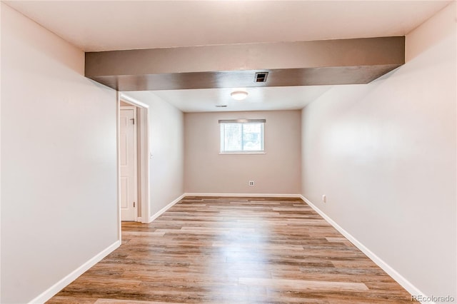 empty room with light wood finished floors and baseboards