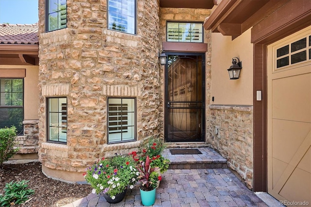 7834 Vallagio Ln, Englewood, CO 80112 - doorway to property featuring stone siding