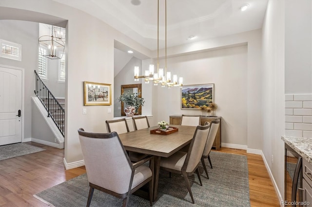 7834 Vallagio Ln, Englewood, CO 80112 - dining space with a chandelier, light wood-type flooring, recessed lighting, wine cooler, and stairway