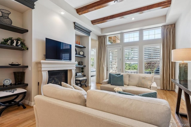 7834 Vallagio Ln, Englewood, CO 80112 - living area with a glass covered fireplace, light wood-style flooring, beam ceiling, built in features, and recessed lighting