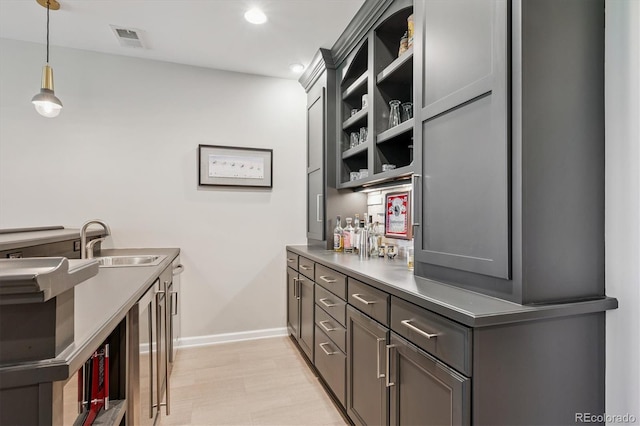 7834 Vallagio Ln, Englewood, CO 80112 - kitchen with open shelves, gray cabinetry, pendant lighting, recessed lighting, and light wood-type flooring