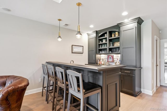 7834 Vallagio Ln, Englewood, CO 80112 - indoor wet bar featuring light wood-style flooring, decorative light fixtures, and recessed lighting