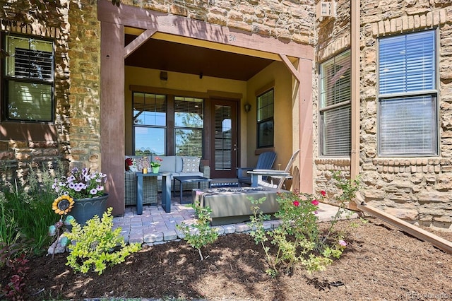 7834 Vallagio Ln, Englewood, CO 80112 - entrance to property with outdoor lounge area, stone siding, and a patio area