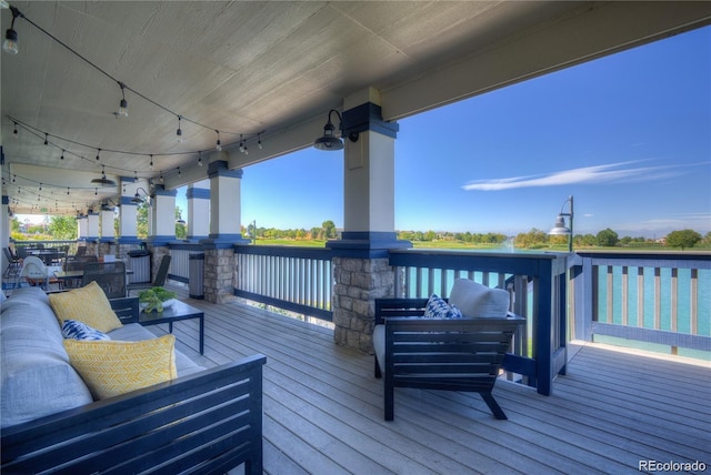 deck featuring a water view and outdoor lounge area