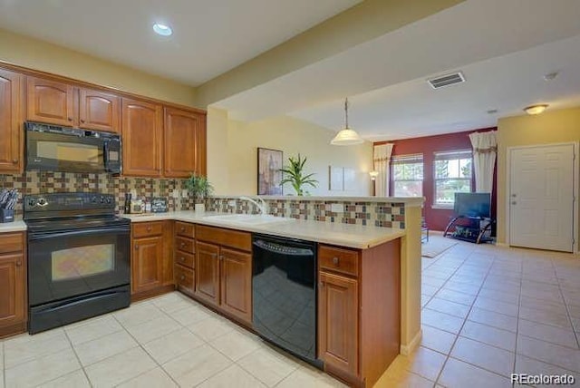 kitchen featuring tasteful backsplash, decorative light fixtures, kitchen peninsula, and black appliances