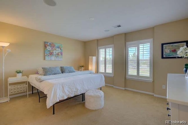 bedroom featuring light colored carpet