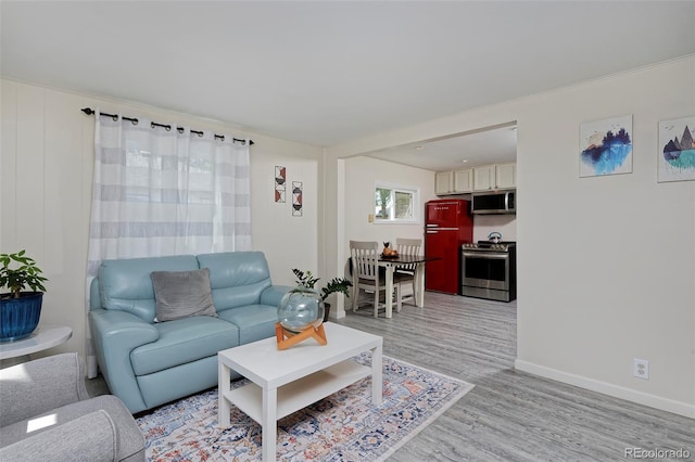 living room featuring light wood-style floors and baseboards