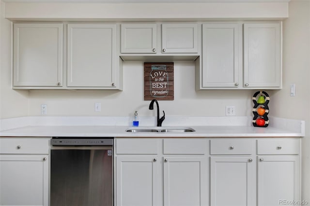 kitchen with a sink, white cabinets, light countertops, and dishwasher