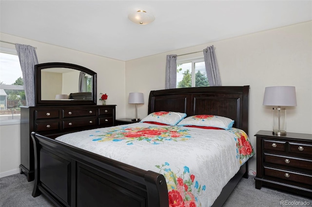 bedroom featuring light carpet and baseboards