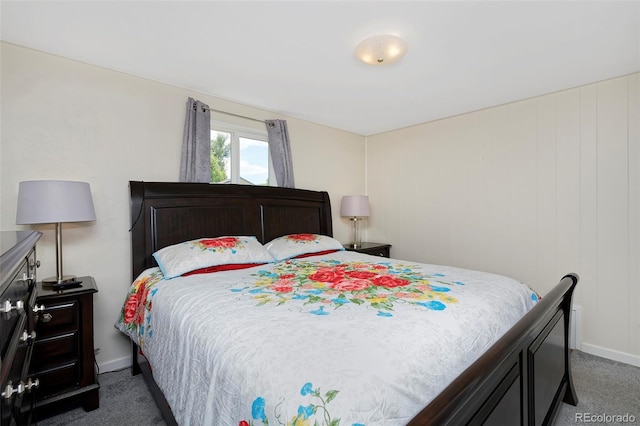 bedroom featuring baseboards and dark carpet