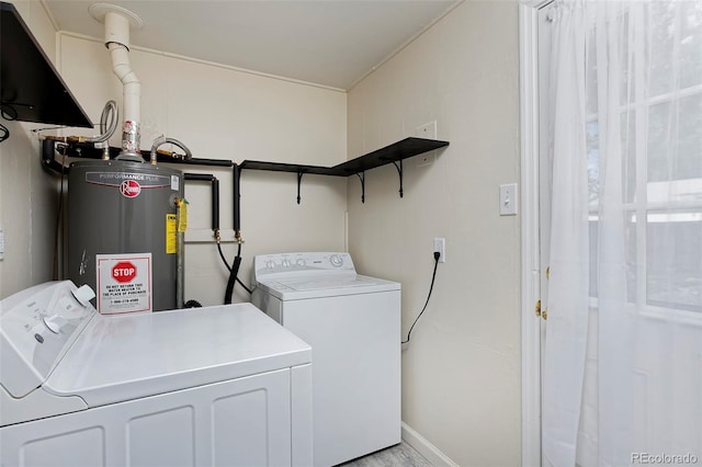 laundry room with laundry area, baseboards, washer and dryer, and gas water heater