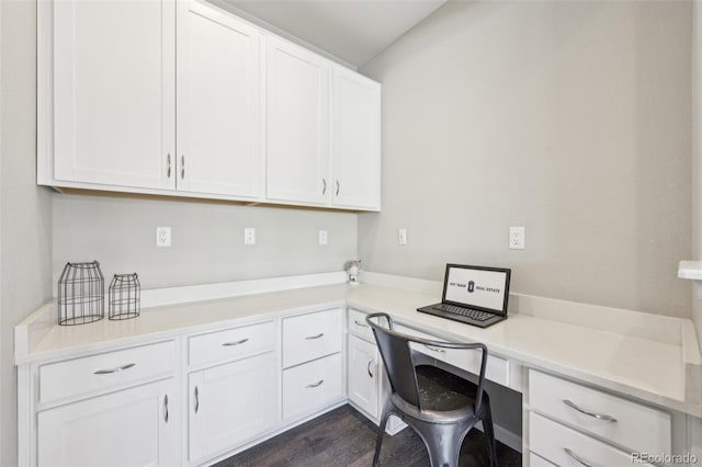 office space featuring built in desk and dark hardwood / wood-style flooring