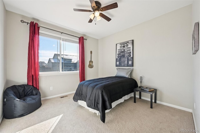 bedroom with light carpet and ceiling fan