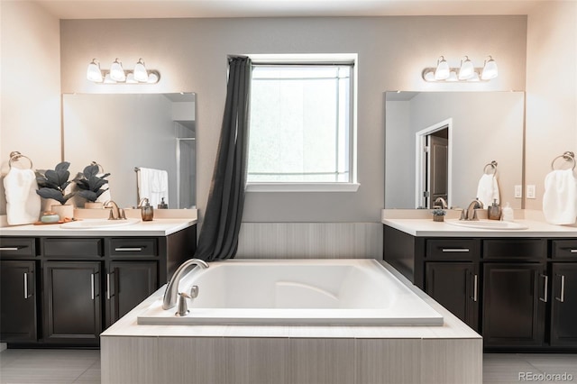 bathroom with vanity, tiled tub, and tile patterned floors