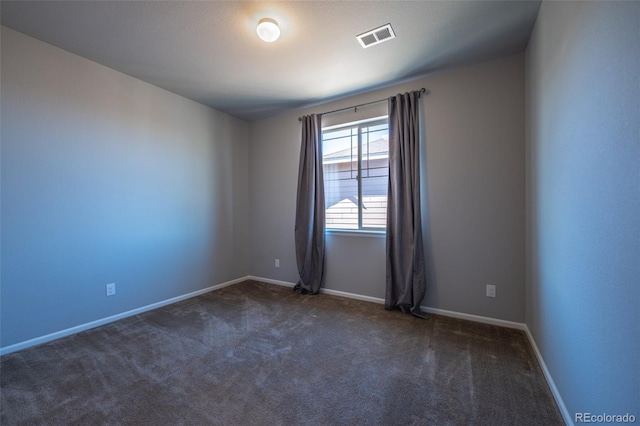 empty room with dark carpet