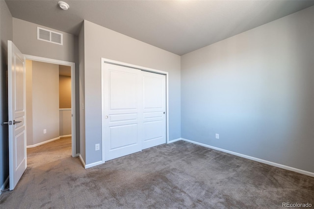 unfurnished bedroom featuring carpet flooring and a closet