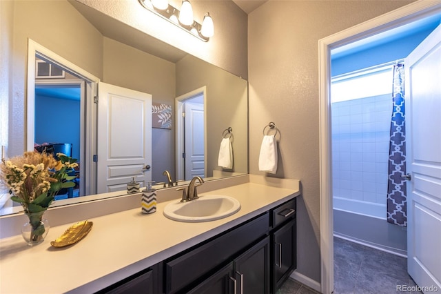 bathroom with tile patterned flooring, vanity, and shower / tub combo