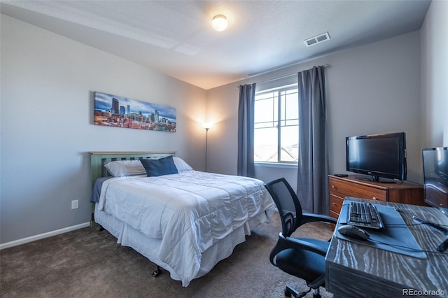 bedroom with dark colored carpet