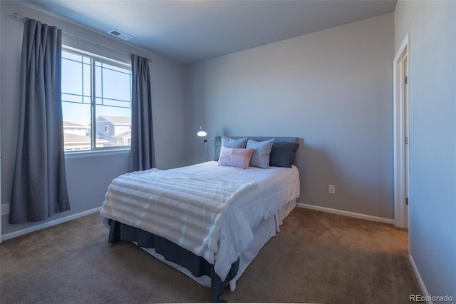 bedroom featuring dark carpet