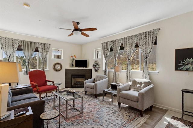 3755 Hartsock Ln Unit 102, Colorado Springs, CO 80917 - living area with a ceiling fan, baseboards, a fireplace, and wood finished floors