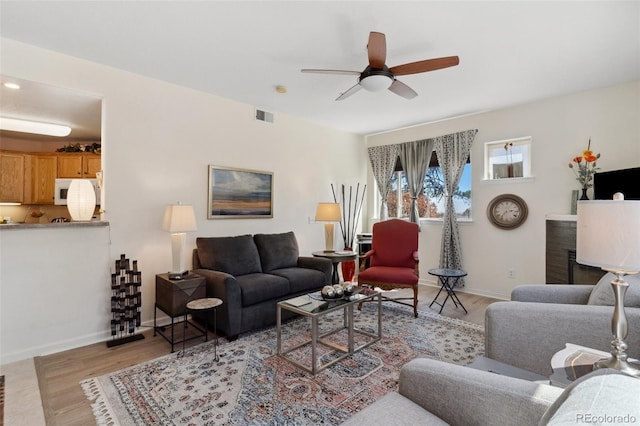 3755 Hartsock Ln Unit 102, Colorado Springs, CO 80917 - living area with ceiling fan, baseboards, and light wood finished floors