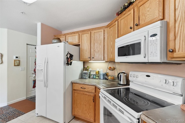 3755 Hartsock Ln Unit 102, Colorado Springs, CO 80917 - kitchen with white appliances, light countertops, light tile patterned floors, and baseboards