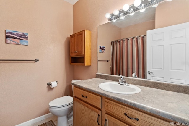 3755 Hartsock Ln Unit 102, Colorado Springs, CO 80917 - bathroom featuring toilet, vanity, curtained shower, and baseboards