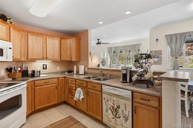 3755 Hartsock Ln Unit 102, Colorado Springs, CO 80917 - kitchen with white appliances, a sink, a peninsula, a ceiling fan, and light tile patterned floors