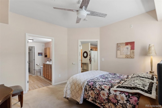 3755 Hartsock Ln Unit 102, Colorado Springs, CO 80917 - bedroom with white fridge with ice dispenser, light carpet, ensuite bath, baseboards, and a ceiling fan