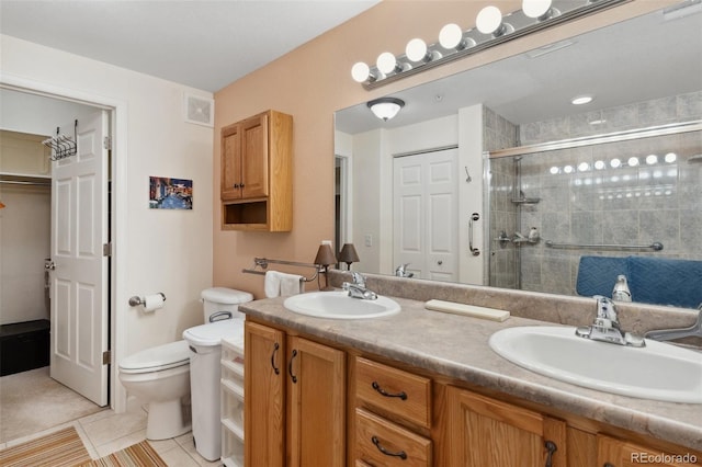 3755 Hartsock Ln Unit 102, Colorado Springs, CO 80917 - bathroom with a closet, a stall shower, toilet, double vanity, and tile patterned flooring