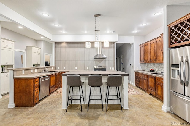 kitchen featuring finished concrete flooring, a center island, stainless steel appliances, light countertops, and pendant lighting