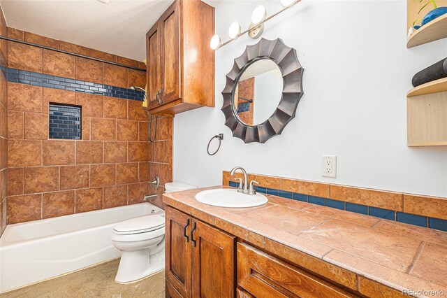 bathroom with shower / bathing tub combination, vanity, and toilet