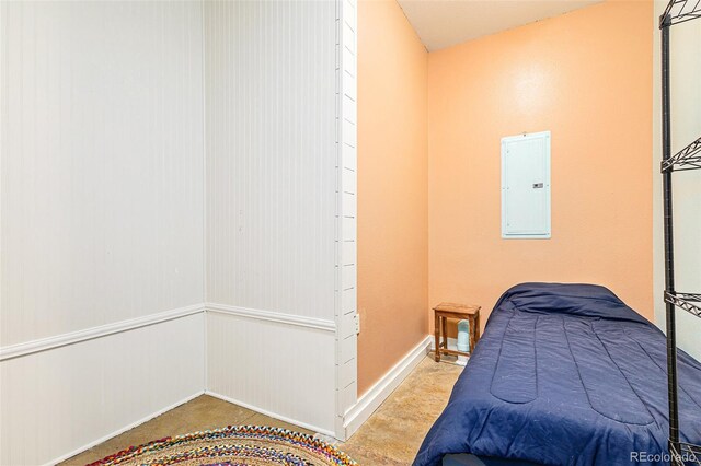 bedroom featuring electric panel and baseboards