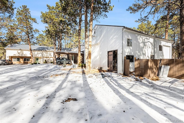 view of front facade featuring a carport and fence