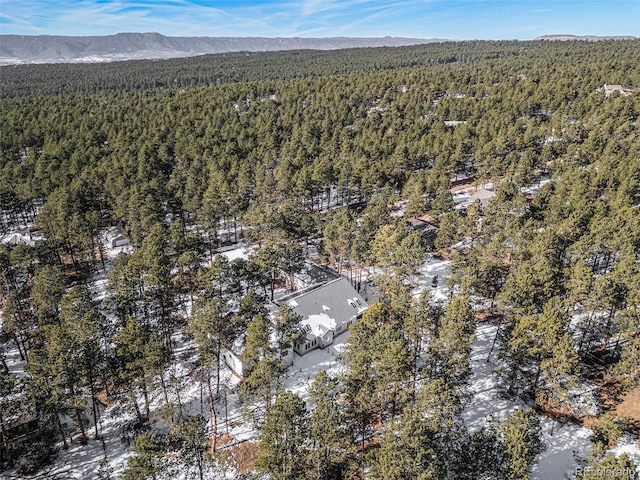 aerial view featuring a mountain view and a wooded view