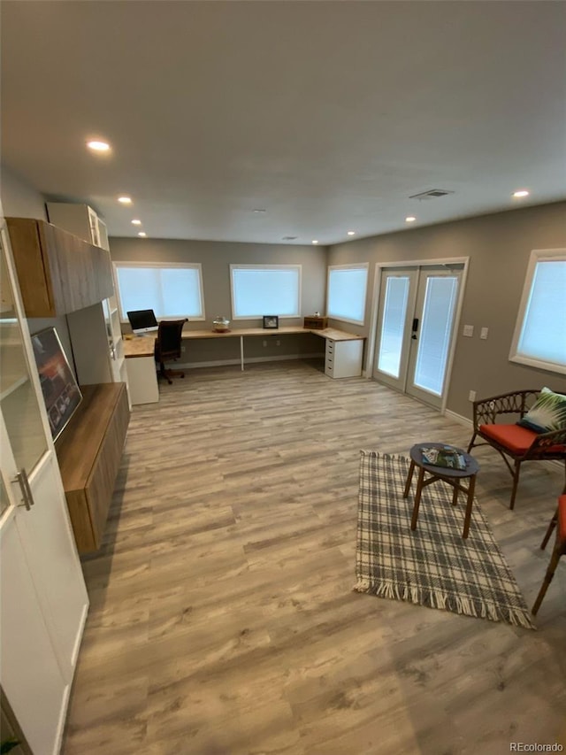 living room featuring light hardwood / wood-style flooring and french doors