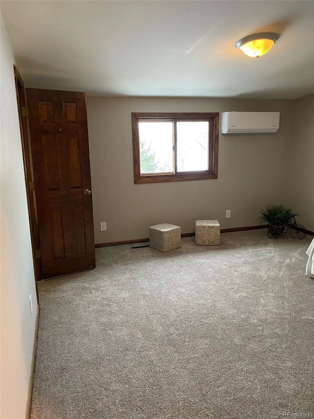 unfurnished room featuring carpet floors and a wall unit AC